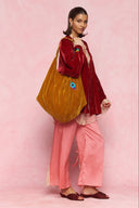 karavan loungewear planet fall winter 26' collection youreye bag orange gold