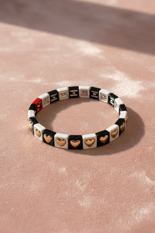 Bracelet with heart and square patterns on a light gray background